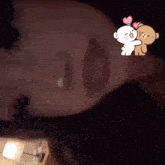 a close up of a woman 's face with a teddy bear with hearts on its head
