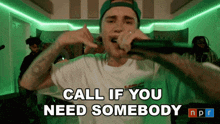 justin bieber singing into a microphone with the words call if you need somebody npr