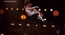 dany hypolito fabio is holding a woman in his arms on a stage