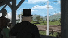 a man in a top hat looks out a window at a train track