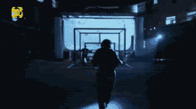 a person standing in a dark room with a sign that says ' a ' on it in yellow