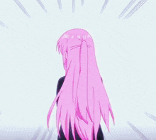 a girl with pink hair is wearing a black jacket and a black shirt .