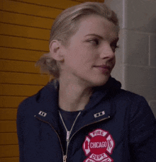 a woman is wearing a chicago fire dept jacket
