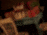 a stuffed animal is sitting in a chair next to a cake