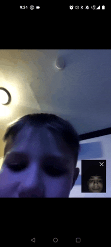 a phone screen shows a man and another man having a video call