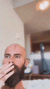 a man with a beard is smoking a cigarette