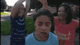 a boy and two girls are making a funny face