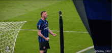 a soccer player wearing a jersey that says jeep stands on the field
