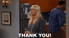 a woman holding a glass of water with the words thank you behind her