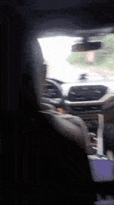 a car is driving down a road with a no parking sign