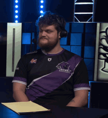 a man wearing headphones and a shirt that says rival on it