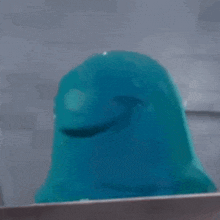 a blue cartoon character with a red eye is looking out a window .