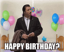 a man in a suit stands in front of balloons and says happy birthday ?