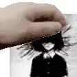 a hand is holding a black and white photo of a girl .