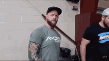 a man with a beard wearing a shirt that says ampe