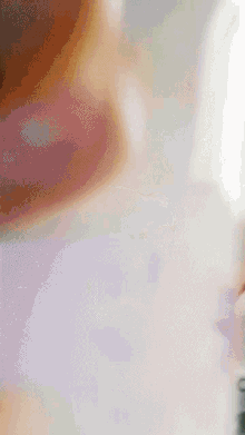a close up of a person 's face with a purple background