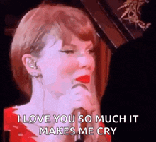 taylor swift is crying while singing into a microphone .