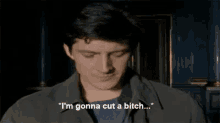 a man is saying " i 'm gonna cut a bitch " in a dark room