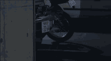 a motorcycle with the license plate 33-64 is parked in a parking lot