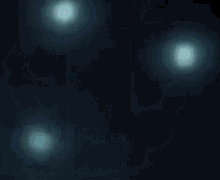 a blue light is coming out of a dark background