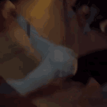 a blurry picture of a person laying on their back on the floor .