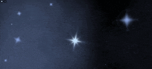 a group of stars are floating in the dark sky .