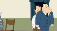 a man in a suit is standing next to another man in a white shirt