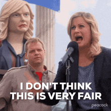 a woman screaming into a microphone with the words " i do n't think this is very fair " on the bottom