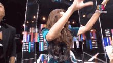 a woman is dancing on a stage with a workpoint logo in the corner