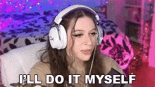 a woman wearing headphones is sitting at a desk in a room .