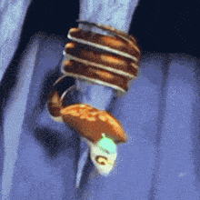 a turtle is hanging upside down with a ring around its head