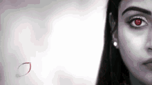 a close up of a woman 's face with red eyes