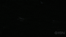 a person holding a gun with ign written on the bottom