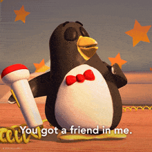 a penguin holding a microphone with the words you got a friend in me