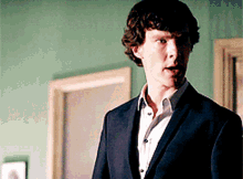 a man in a suit is standing in a room