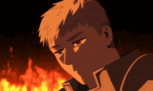 a man is standing in front of a fire and looking down