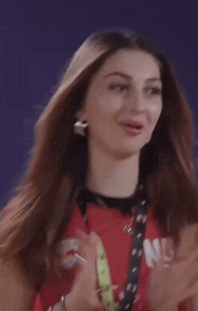 a woman wearing a red shirt that says ' redbull ' on it