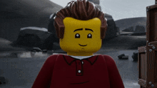 a close up of a lego man with a red shirt on