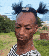 a man wearing a striped shirt with pigtails on his head