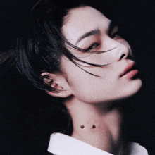 a close up of a person 's face and neck with a tattoo on it