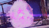 a large purple object is hanging from a fence