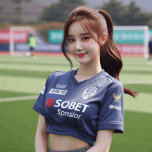 a woman wearing a blue shirt that says sobet sponsor
