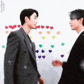 two men in suits are standing next to each other in front of a wall with hearts on it and the words forcebook corner on the bottom