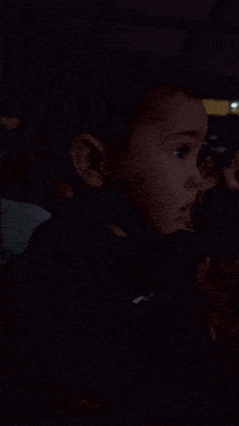 a young boy wearing a black shirt that says ' n ' on it