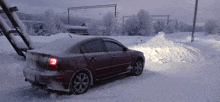 a car is parked in a snowy area with a large pile of snow