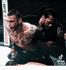 a man in a cage with a sign that says ufc 3