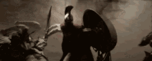 a man in a spartan helmet is holding a sword and shield in a battle scene .