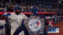 a baseball player wearing a blue jays jacket hugs another player