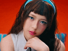 a close up of a woman 's face with a blue headband