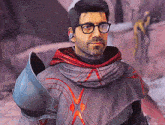 a man wearing glasses and a hooded cape is standing in front of a rock wall .